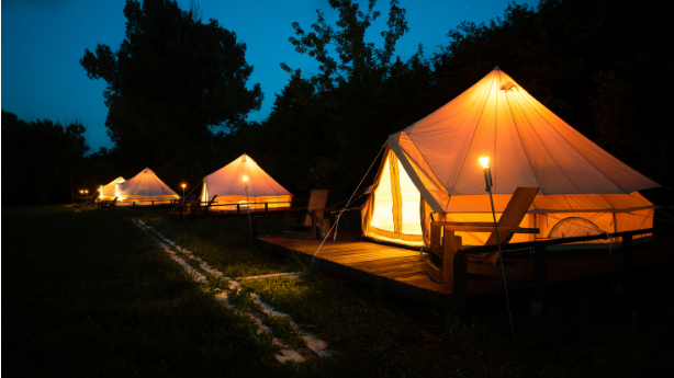 A row of tents lit up at night