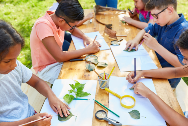 Kids sitting at a table doing activities