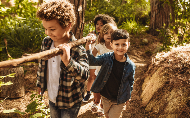 Children hiking with a stick