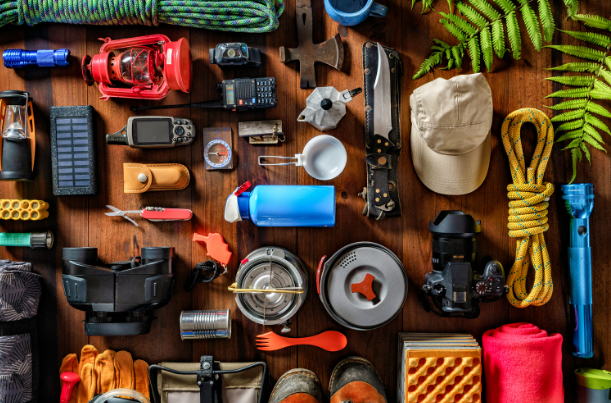 Various camping gear laid out on a table