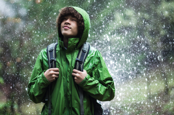 Man hiking in rain with waterproof jacket