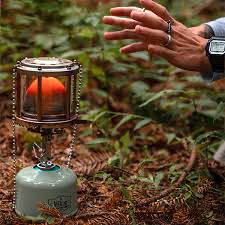 A person warming their hands by a propane portable heater