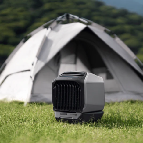 Camping air conditioner sitting next to camping tent.