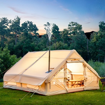 tent in field with smoke coming out of chimney