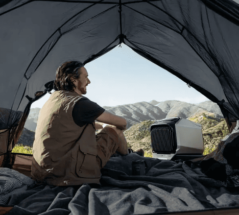 Man in tent with camping air conditioner