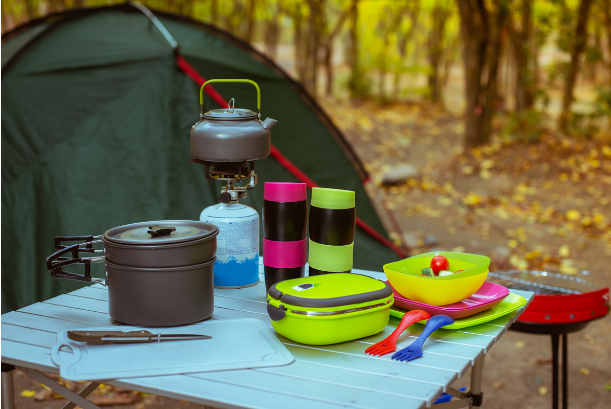 Camping cooking supplies sitting on a picnic table