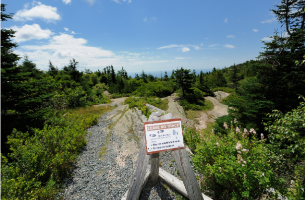 A sign on a trail 