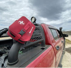 Off road truck with first aid kit attached to side