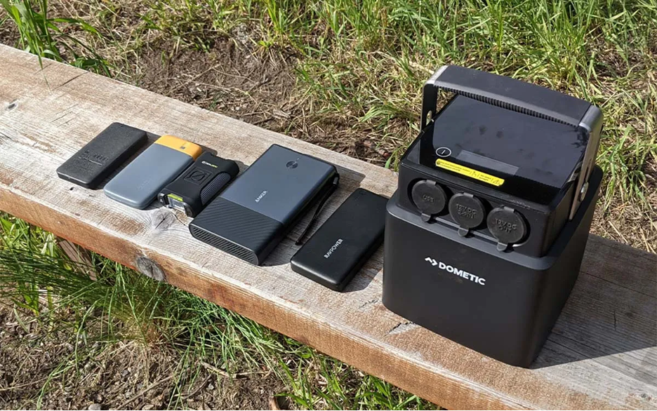 A group of electronic charging devices sitting on a bench