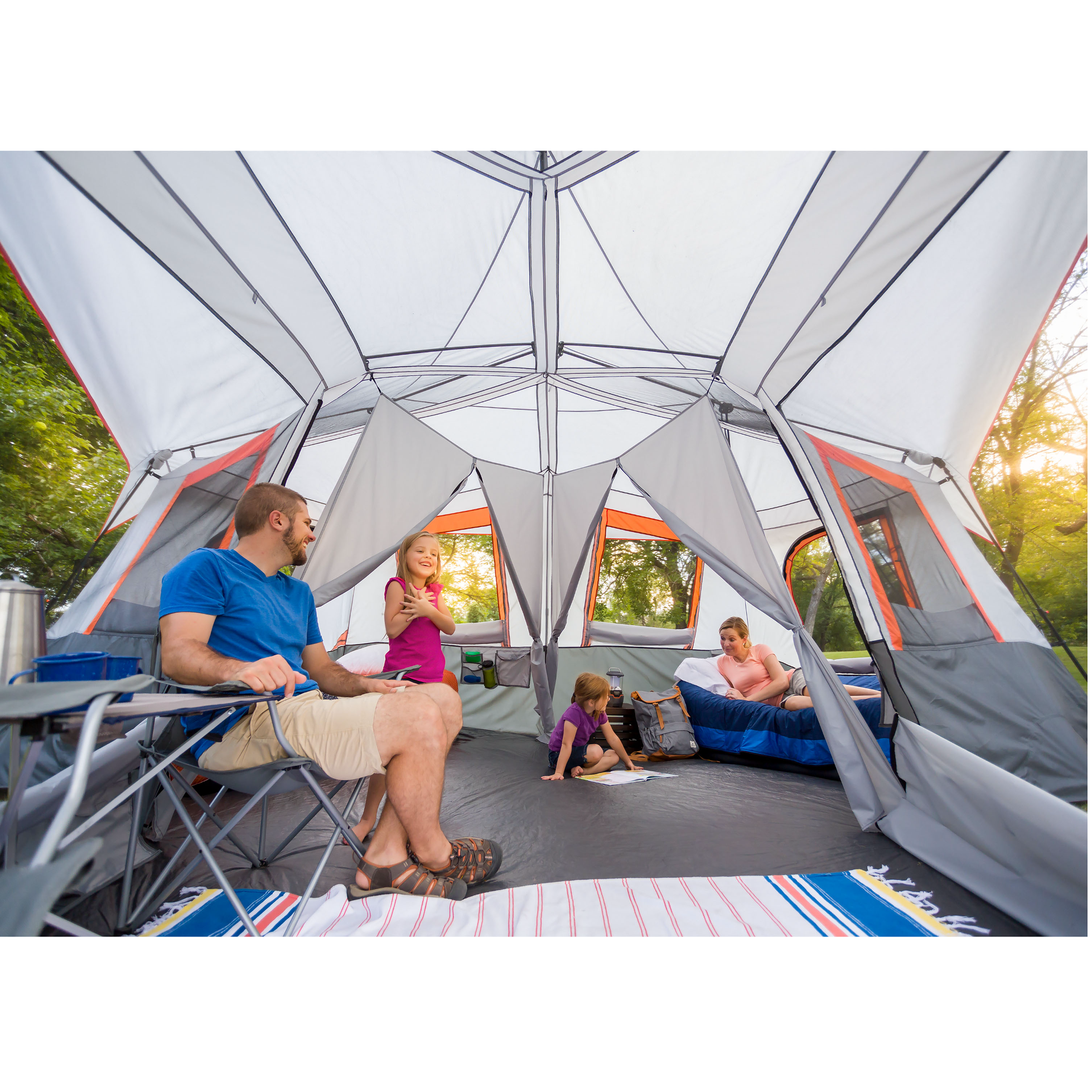 A family sitting inside a tent