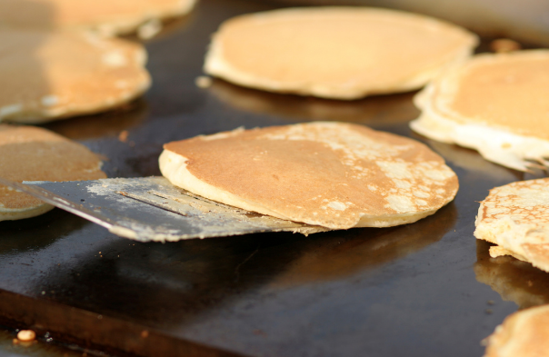 Pancakes cooking on a griddle