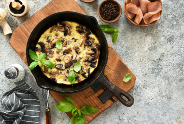 cast iron skillet with a frittata cooked in it sitting on a table