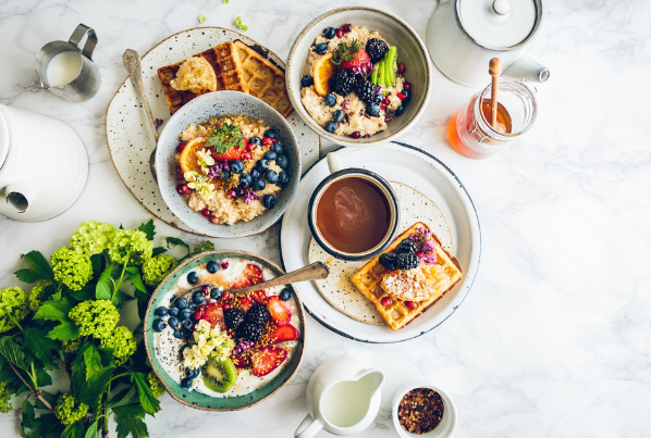 Breakfast ingredients on a table with waffles