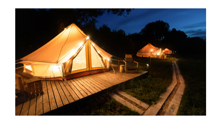 Inflatable tent on a deck lit up at night