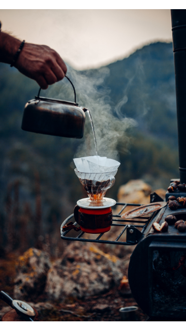 person pouring hot water into coffee filter