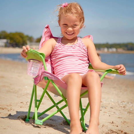 Little Girl sitting in chair at the beach