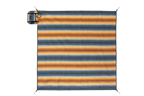 a spread out stripped camping blanket